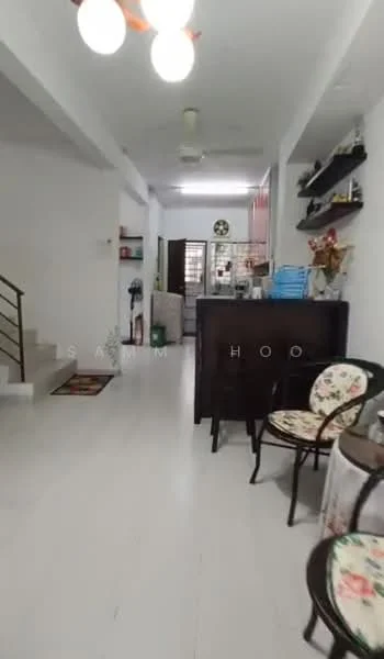 Room features: white painted walls, light-colored flooring, ceiling with pendant light, staircase with metal railing, wooden cabinets, open shelving, decorative chairs, kitchen area visible in background, greenery visible in background, wall-mounted decorations; style: modern.