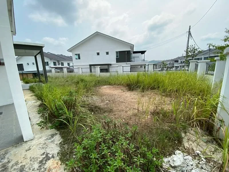 Exterior features: overgrown grass, dirt patch, surrounding residential buildings, fenced perimeter, paved walkway, utility poles, cloudy sky.