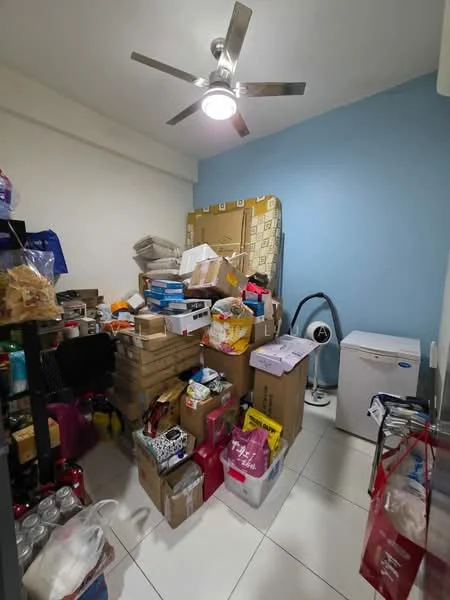 Room features: white painted walls, blue accent wall, ceiling fan with light, tile flooring, stacked boxes, storage bins, small fridge, various household items.
