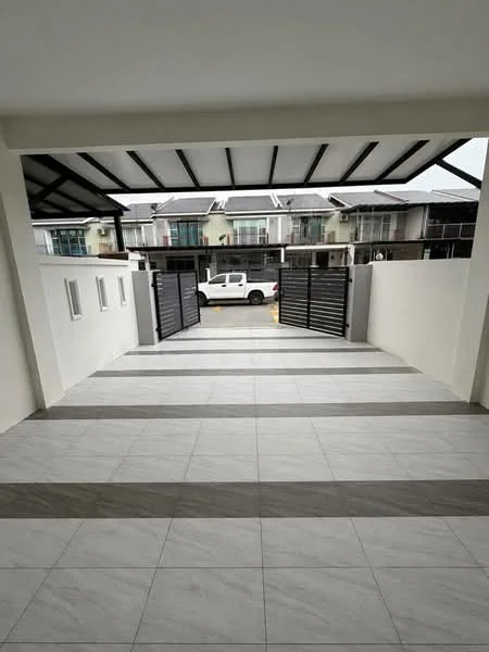 Exterior type: linked terrace house; features: gated entrance with sliding metal gates, paved driveway with grey and white tiles, covered car porch with metal roofing, surrounded by residential houses, white painted walls, concrete fence, modern architectural design; style: modern.