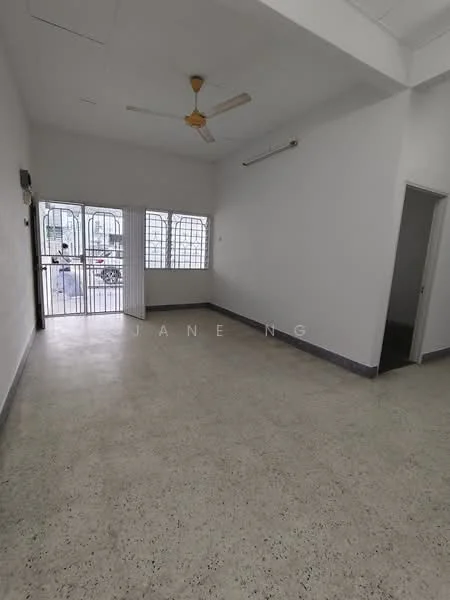 Room features: white painted walls, polished concrete flooring, 5-blade ceiling fan, multiple windows with metal grilles, door leading outside, light-colored ceiling, neutral color scheme, open layout; style: minimalist.