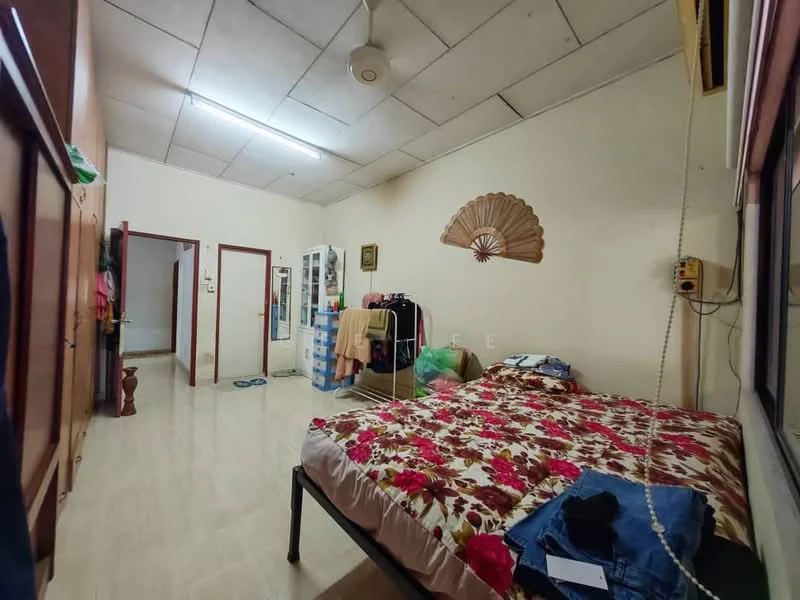 Bedroom features: queen-size bed with floral bedding, wooden wardrobe with sliding doors, wooden flooring, ceiling fan, wall-mounted air conditioning unit, window with curtains, decorative wall fan, mirror cabinet, clothes on the floor, open space leading to another room.