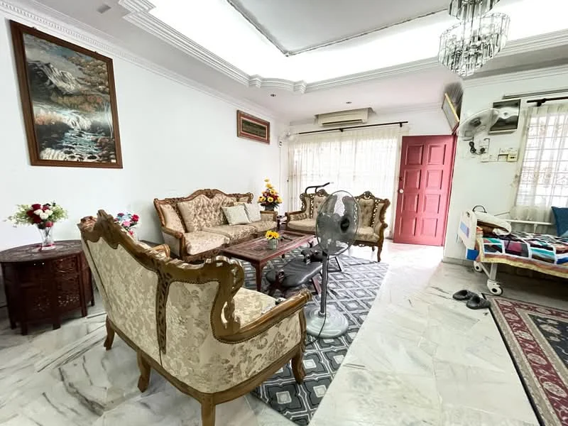 Living features: white painted walls, marble flooring, tray ceiling, chandelier, sofa set with floral upholstery, wooden coffee table, decorative wall art, floor fan, curtains, area rug with geometric pattern, side table with flowers, armchairs with ornate wood detailing, sliding glass door, window with sheer curtains; style: traditional.