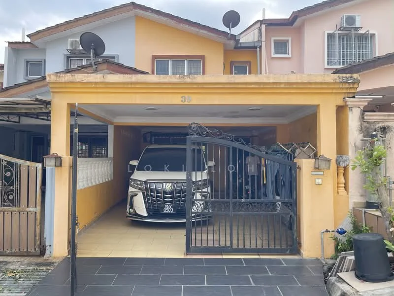 Exterior type: linked terrace house; features: yellow painted facade, gated entrance, car porch with awning, paved driveway, single-storey, visible car inside garage, satellite dishes on roof, manicured landscaping, security gate, front garden area; style: modern.
