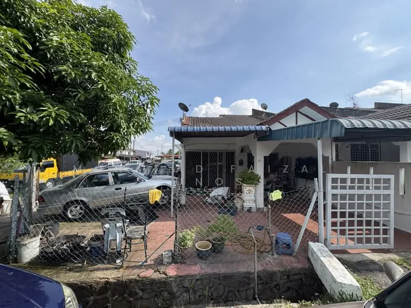 Exterior type: semi-detached house; features: single-storey, front porch with tiled flooring, fenced yard, garden area with potted plants, car parking space, metal roof with overhang, satellite dishes on roof, visible vehicles in driveway, manicured landscaping, brick wall fencing; style: traditional.