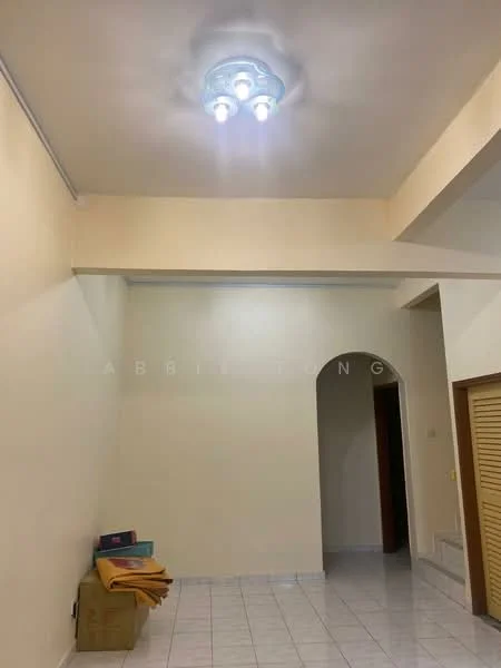 Room features: white painted walls, flat ceiling with light fixture, ceramic tile flooring, arched doorway, built-in wardrobe with louvered doors, stack of towels or blankets, neutral color scheme.