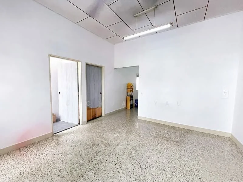 Room features: white painted walls, polished concrete flooring, fluorescent ceiling lights, two doorways, no visible furniture, neutral color scheme, open layout, high ceiling; style: minimalist.