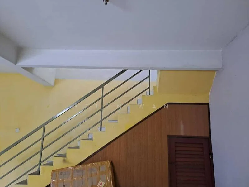 Room features: yellow painted walls, white ceiling, metal railing, wooden door, wooden paneling, staircase, laminate flooring, decorative wall panel; style: modern.