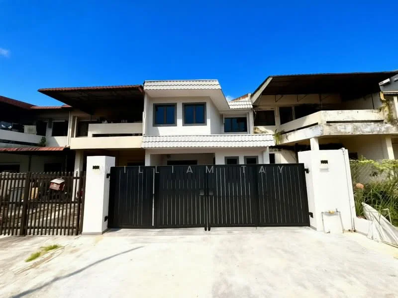 Exterior type: semi-detached house; features: black metal gate, two-storey structure, flat roof, white painted facade, balconies on upper level, concrete driveway, surrounding greenery, visible neighboring houses; style: modern.