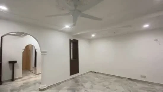Room features: white painted walls, marble flooring, 5-blade ceiling fan with light, recessed downlights, arched doorway, window with brown frame, corner column with decorative detailing, neutral color scheme; style: modern.