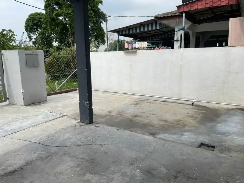 Exterior features: concrete flooring, fenced perimeter, white painted wall, gate access, surrounding greenery, open space.