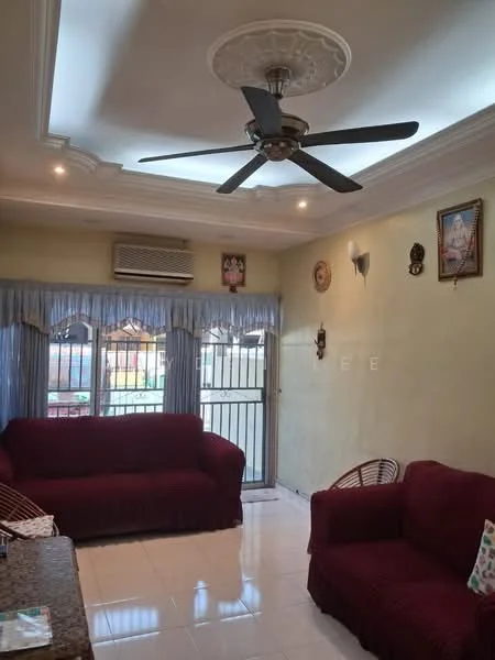 Living features: 5-blade ceiling fan with integrated light, cream painted walls, white tiled flooring, two red fabric sofas, decorative wall clock, wall-mounted air conditioning unit, curtains on windows, window with security bars, decorative wall art; style: traditional.