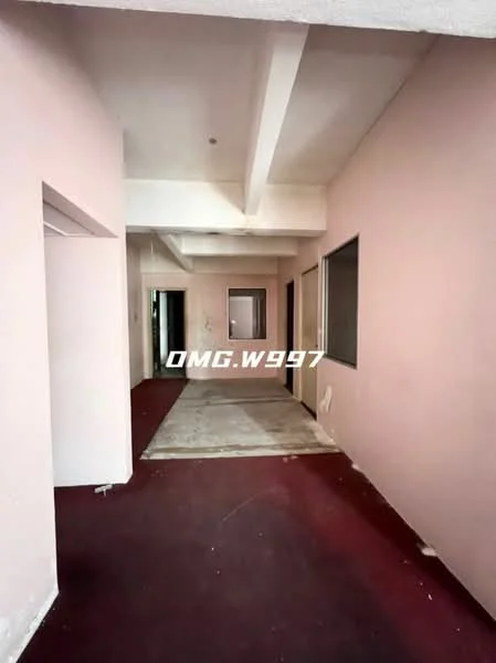 Room features: pink painted walls, exposed ceiling beams, carpet flooring in dark red, concrete flooring, multiple doorways, windows with no visible treatments.