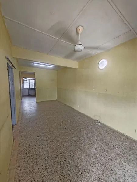 Room features: yellow painted walls, exposed ceiling, ceiling fan, terrazzo flooring, window with grille, light fixture, wall-mounted air vent, open layout.