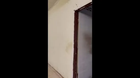 Room features: plain white walls, light-colored flooring, door frame, visible corner of a wall.
