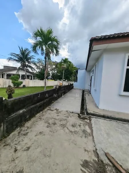 Exterior type: detached bungalow; features: white painted facade, flat roof, concrete pathway, landscaped garden, palm trees, fenced perimeter, manicured lawn, adjacent residential properties; style: modern.