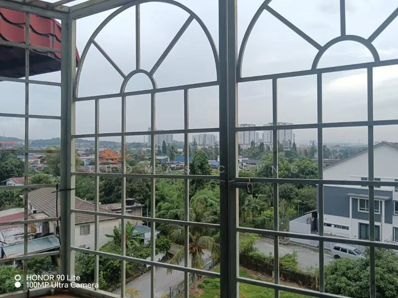 Room features: metal window frame, grid pattern on window, view of city skyline, view of greenery, overcast sky; view: city.