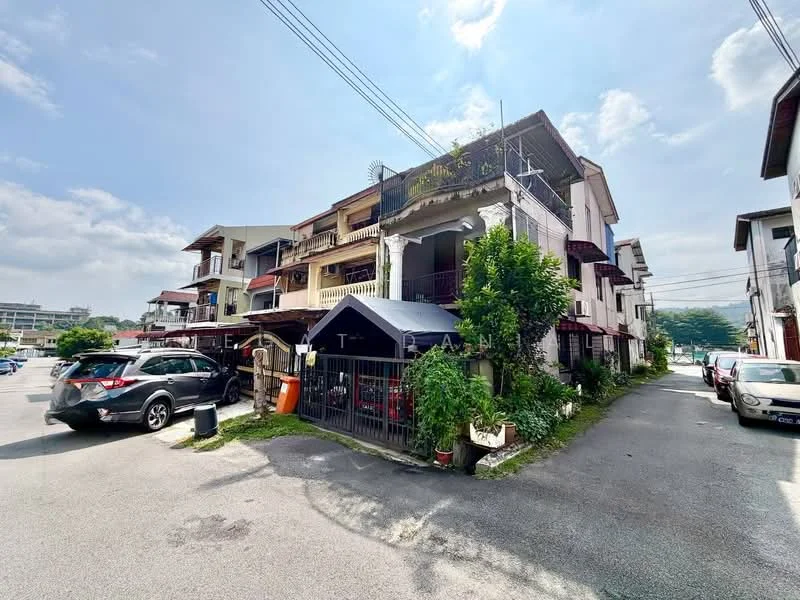 Exterior type: linked terrace house; features: two-storey building, white painted facade, red tiled roof, balconies on upper floor, manicured greenery, car porch with awning, driveway with interlocking pavers, surrounded by residential area, visible parking spaces, street view, utility poles with overhead wiring; style: traditional.