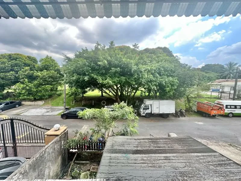Exterior features: greenery with large trees, paved road, parked vehicles, residential area, cloudy sky, fence in foreground.