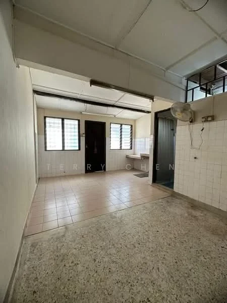 Room features: white painted walls, tile flooring, ceiling fan, window with metal grille, door leading to another room, kitchen area with countertop, light fixture, exposed ceiling, wall-mounted electrical outlet.