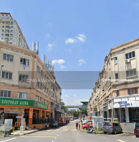 Exterior type: shophouse; features: two-storey shophouse, commercial units on ground floor, residential units on upper floor, signage on storefronts, balconies on upper level, street view with vehicles, surrounding urban environment, visible telecommunications antennas, paved road, sidewalks; style: traditional.