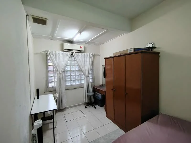 Bedroom features: white painted walls, tile flooring, window with sheer curtains, 1 wall-mounted split AC, built-in wardrobe, study desk, office chair, bedside table, double bed, desk lamp.