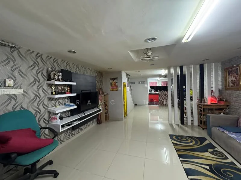 Living features: white painted walls, grey accent wall with wavy pattern, polished ceramic tile flooring, recessed downlights, 5-blade ceiling fan, wall-mounted TV, black TV console, decorative shelving unit, area rug with geometric pattern, sofa with cushions, wooden dining table, green office chair; style: modern. Kitchen features: open kitchen layout, red cabinetry, kitchen countertop, stainless-steel appliances, wall-mounted shelves; style: modern.