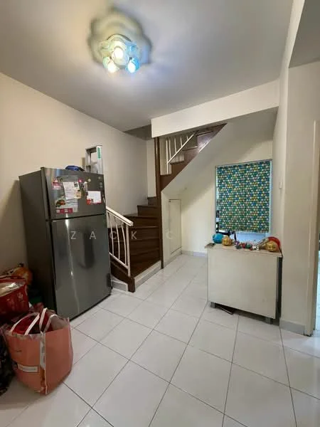 Room features: white painted walls, white tiled flooring, stainless-steel fridge, wooden staircase, stair railing, blue patterned window treatment, small white cabinet, decorative items on cabinet, bags on the floor; style: modern.