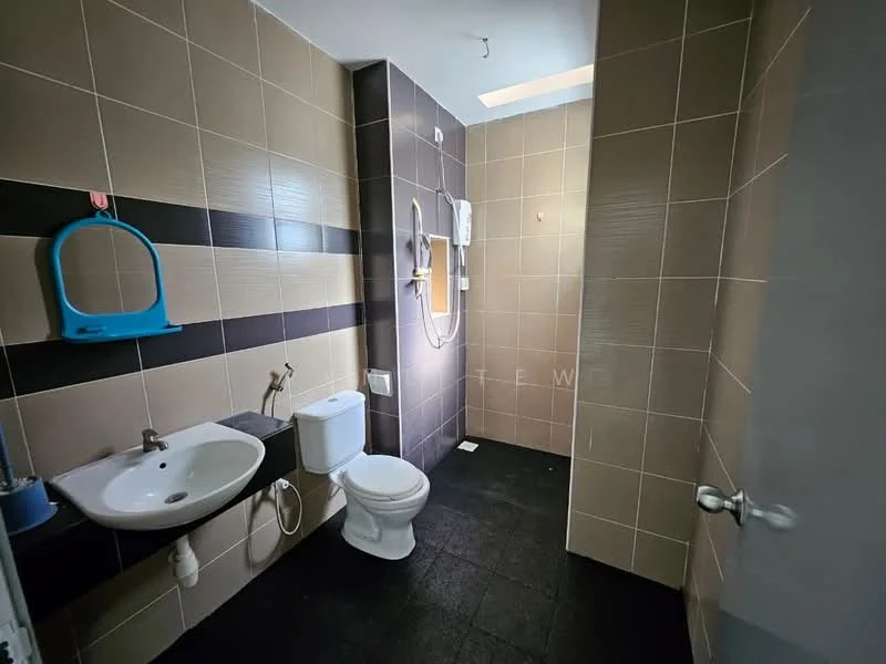 Bathroom features: wall-mounted sink, white ceramic toilet, shower with glass partition, wall-mounted shower head, black and brown tiled walls, black tile flooring, mirror above sink, toilet paper holder, soap dispenser, water heater, blue wall-mounted mirror, light fixture in ceiling; style: modern.