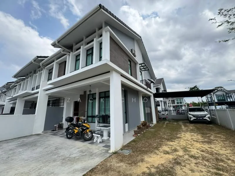 Exterior type: linked terrace house; features: two-storey building, grey and white painted facade, flat roof, car porch with awning, manicured lawn, paved driveway, balcony on upper floor, visible windows with black frames, surrounded by greenery, motorcycle parked in front, car parked under carport; style: modern.