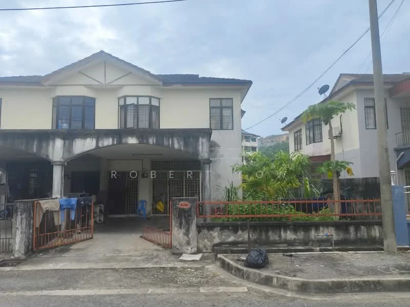 Exterior type: linked terrace house; features: two-storey building, white painted facade, black roof tiles, front garden with greenery, metal gate, concrete driveway, visible parking area, surrounded by other residential buildings, satellite dishes on roof, fenced perimeter; style: traditional.