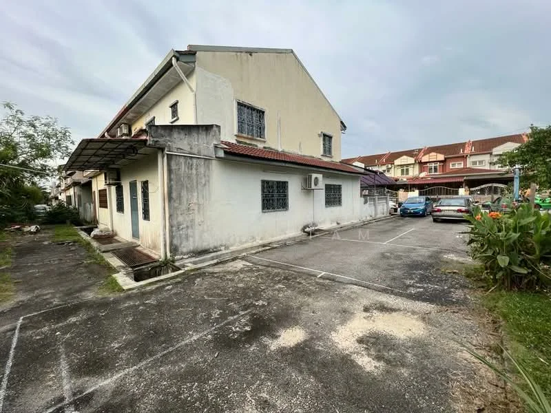 Exterior type: semi-detached house; features: two-storey building, exposed concrete facade, red tiled roof, window grilles, air conditioning unit on wall, concrete driveway, parking space for multiple cars, surrounding greenery, manicured garden area, adjacent residential buildings; style: traditional.