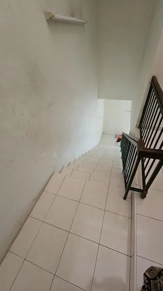 Room features: white painted walls, white tiled flooring, staircase with wooden railing, light fixture on wall, open space at the top of the stairs.