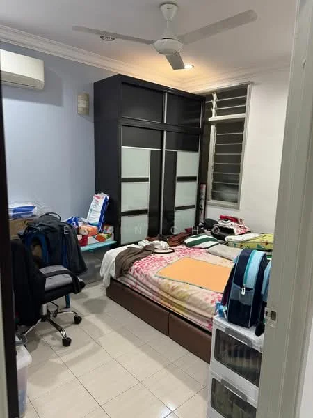 Bedroom features: queen-size bed with patterned bedding, built-in wardrobe with sliding doors, study desk with chair, window with blinds, wall-mounted air conditioning unit, ceiling fan, tile flooring, decorative wall with light blue paint, stacked storage drawers, cluttered workspace with books and bags.