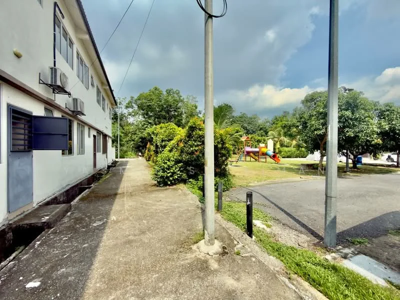 Exterior type: low-rise apartment block; features: concrete pathway, landscaped greenery, playground equipment, mature trees, wall-mounted split AC units, power pole, open parking area; style: modern.