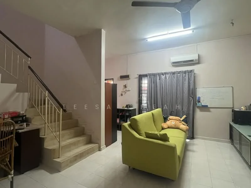Living features: green fabric sofa, ceiling fan, wall-mounted air conditioning unit, white tiled flooring, light pink painted walls, curtains, TV console, desk with chair, staircase with white railing; style: modern.
