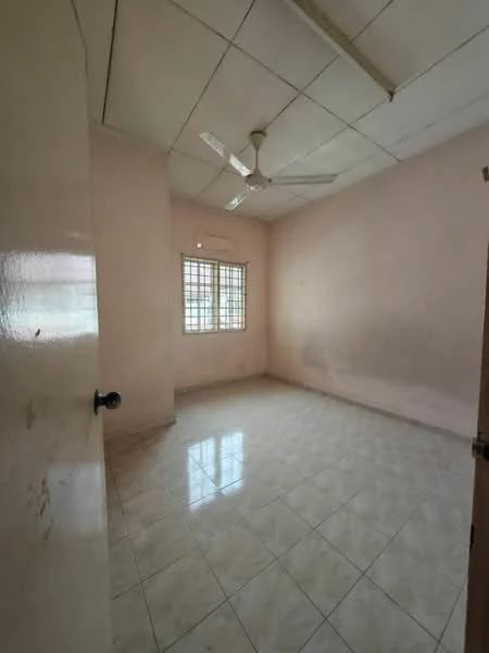 Room features: light pink painted walls, white tiled flooring, ceiling fan, window with metal grille, plain ceiling, no visible furniture, natural light from window.