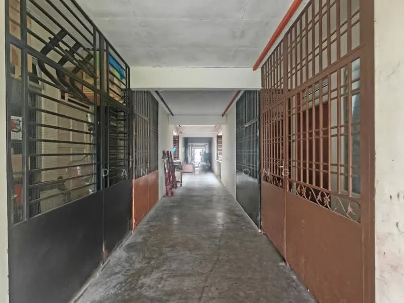 Room features: concrete flooring, metal grilles on both sides, painted walls, overhead lighting, long corridor layout, multiple doorways, open space, neutral color scheme.