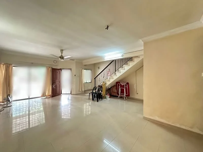 Living features: cream painted walls, polished ceramic tile flooring, 5-blade ceiling fan with light, floor-to-ceiling windows, sheer curtains, wooden front door, staircase with metal railing, decorative wall clock, two black plastic chairs, small potted plant.