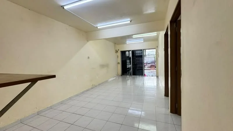 Room features: white painted walls, glossy white tile flooring, fluorescent ceiling lights, open layout, sliding glass door, metal security grille, window with view to outdoor area, wooden door, table or countertop, neutral color scheme; style: minimalist; view: garden.