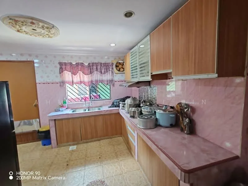 Kitchen features: pink tiled backsplash, wood cabinetry, double-bowl stainless-steel sink, chrome pull-down faucet, built-in stove, multiple cooking pots, kitchen countertop, window with patterned curtains, vinyl flooring, ceiling light fixture, wall-mounted fan; style: traditional.