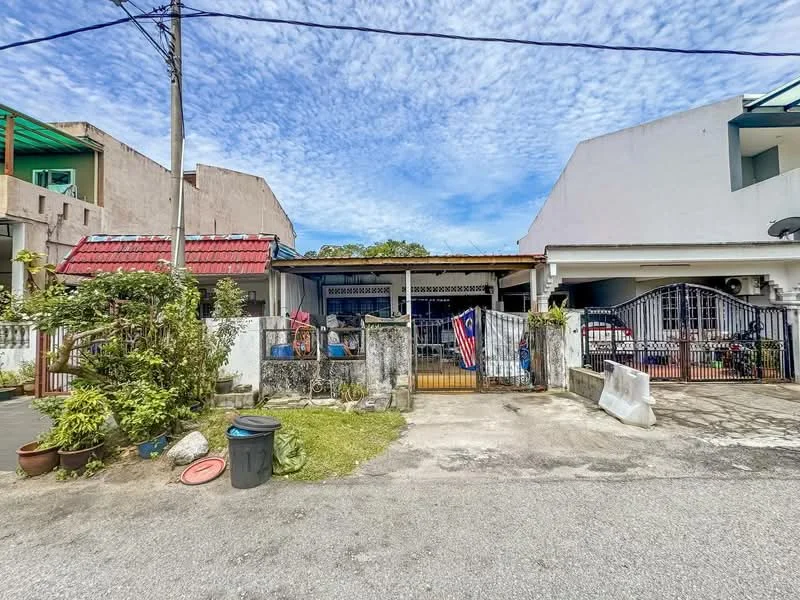 Exterior type: semi-detached house; features: white painted facade, red tiled roof, metal gate, fenced front yard, paved driveway, garden area with plants, visible car parked in driveway, adjacent houses on both sides, overhead power lines, clear blue sky; style: traditional.