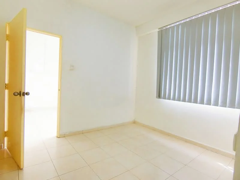 Room features: white painted walls, tile flooring, vertical blinds on window, single door, light-colored door frame, natural light from window.