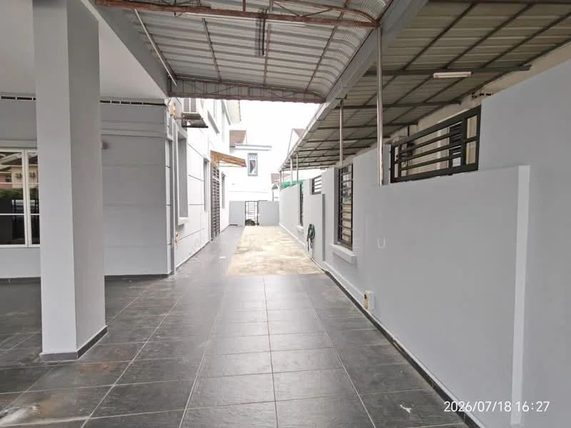 Exterior features: grey painted walls, black tiled flooring, covered walkway, manicured lawn, side access path, fenced perimeter, outdoor lighting, sliding glass door, windows with grills; style: modern.