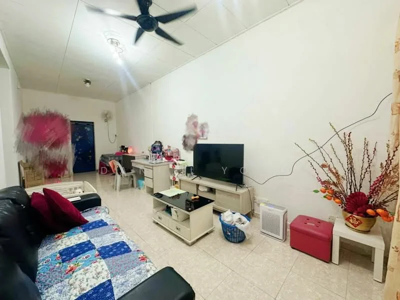 Living features: black leather sofa, multi-coloured patchwork throw, white painted walls, tile flooring, ceiling fan, wall-mounted TV, white TV console, decorative vase with flowers, small pink ottoman, basket for storage, small side table.