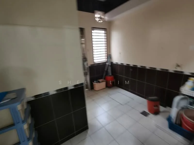 Room features: white painted walls, dark brown tiled walls, white floor tiles, window with horizontal bars, ceiling light fixture, cleaning supplies visible, shelves, buckets.