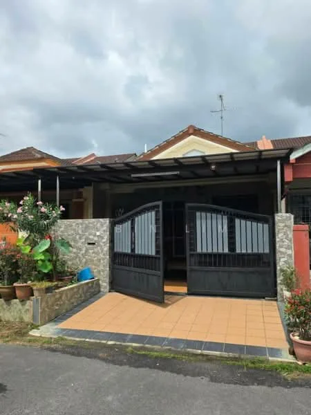 Exterior type: linked terrace house; features: black metal gate, stone cladding at entrance, tiled pathway, covered porch, manicured garden with plants, single-storey, roof with overhang, visible antenna on roof; style: modern.