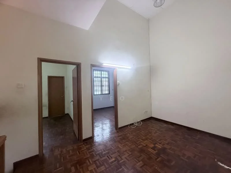 Room features: white painted walls, parquet wood flooring, sloped ceiling, single ceiling light fixture, window with grid pattern, doorway leading to another room, doorway leading to hallway.