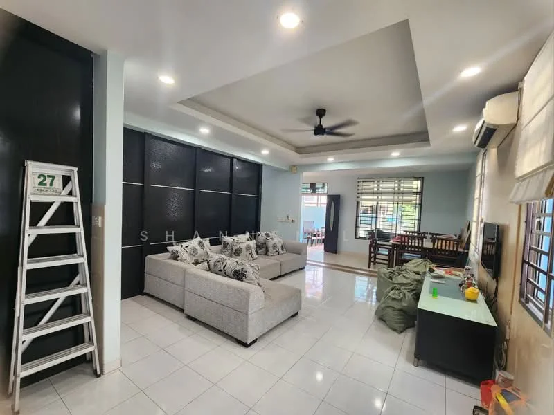 Living features: L-shape sectional sofa in light grey, decorative cushions, ceiling fan with light, recessed downlights, wall-mounted TV, TV console in black, white tiled flooring, large windows with sheer curtains, decorative wall paneling, dining area visible in background, ladder leaning against wall, green bean bags on floor; style: modern.
