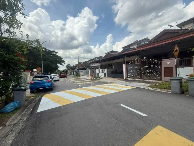 Exterior type: linked terrace house; features: two-storey linked terrace houses, red tiled roofs, white painted facades, driveways with interlocking pavers, manicured lawns, street with speed bumps, garbage bins at curbside, trees lining the street, cloudy sky, blue car parked on the street; style: modern.